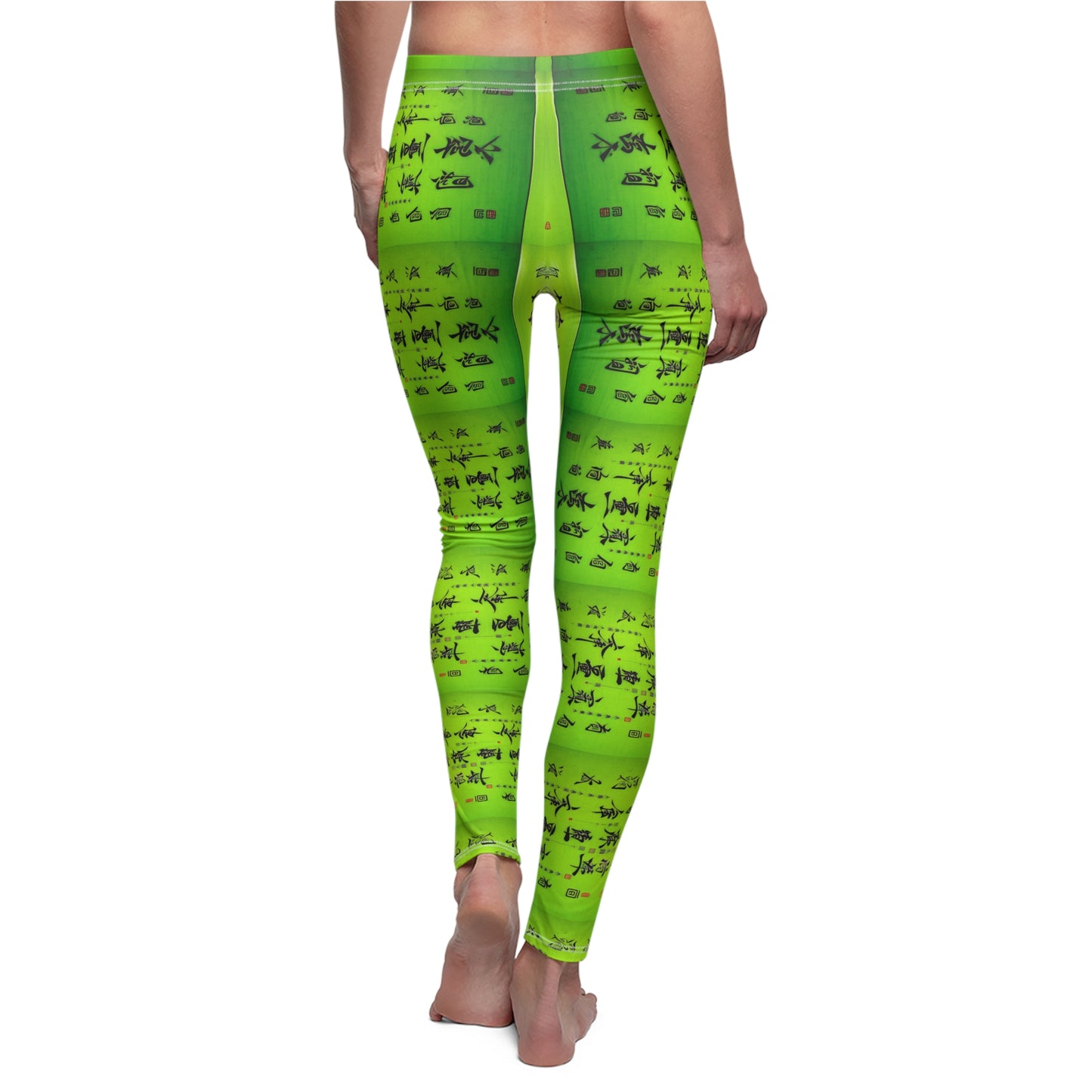Back view of a model wearing a pair of lime green elastic skinny fit leggings with a pattern of Chinese calligraphy.