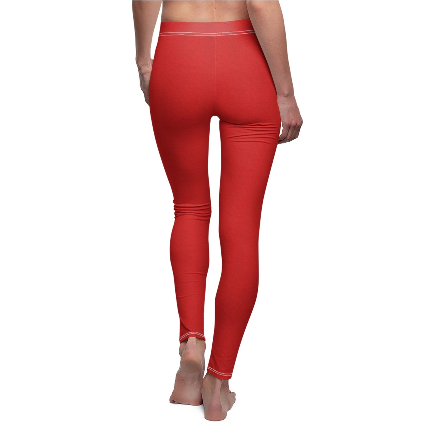A pair of solid red skinny fit leggings with white thread color at the elastic waistband.