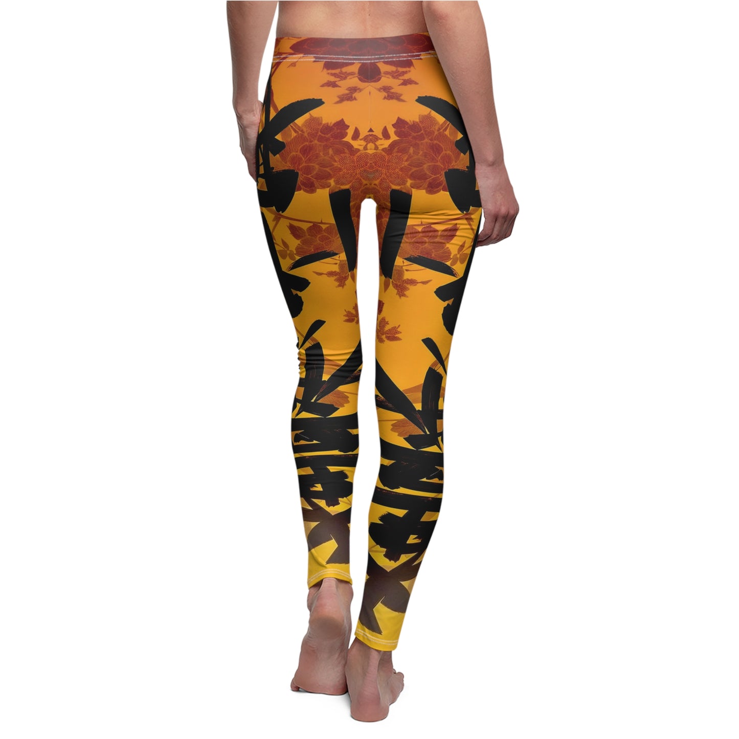 A pair of skinny fit leggings featuring a gold and orange color scheme with an Oriental geometric floral pattern, back view, worn by model.