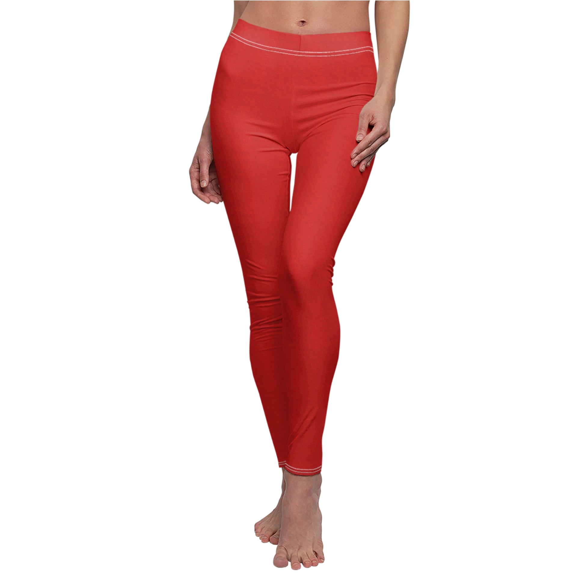 A pair of solid red skinny fit leggings with white thread color at the elastic waistband.