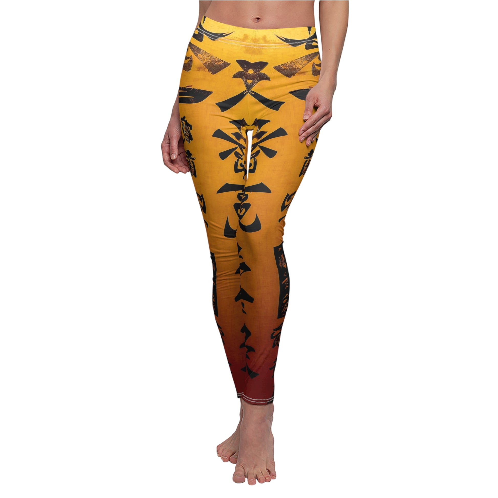 Front view of model wearing a pair of skinny fit leggings featuring a gold color with black geometric patterns and a visible white thread color.