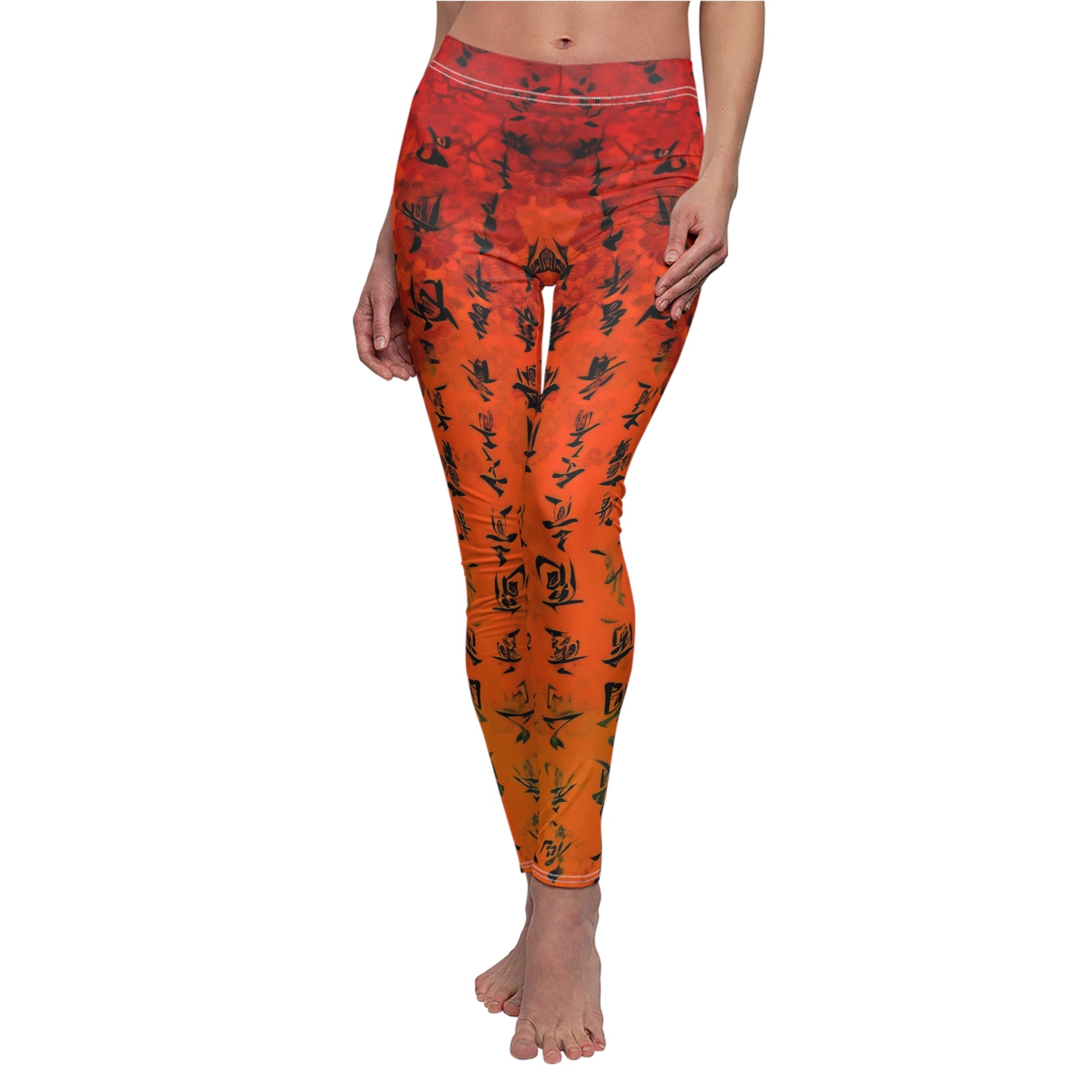 A pair of red and orange leggings with black character patterns, worn by a model posing with one hand on her hip.