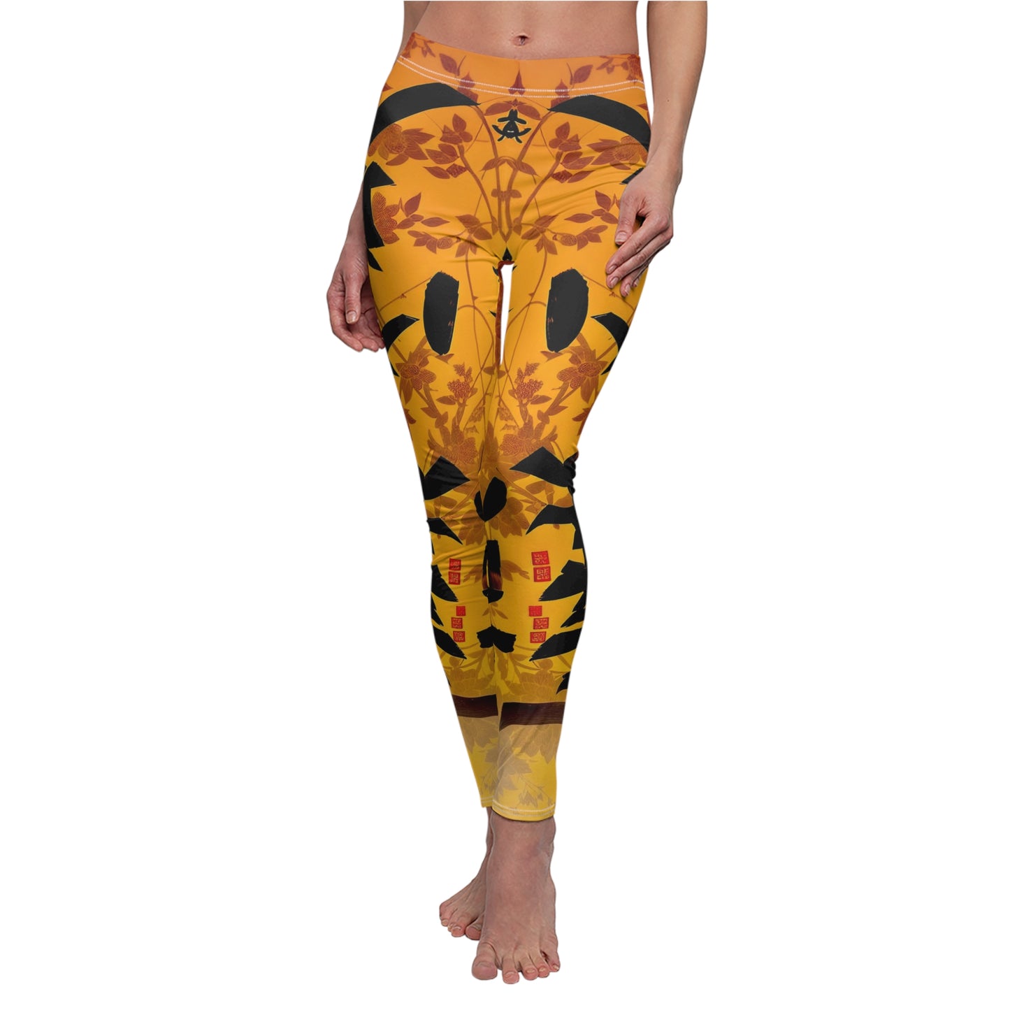 A pair of skinny fit leggings featuring a gold and orange color scheme with an Oriental geometric floral pattern, worn by model.
