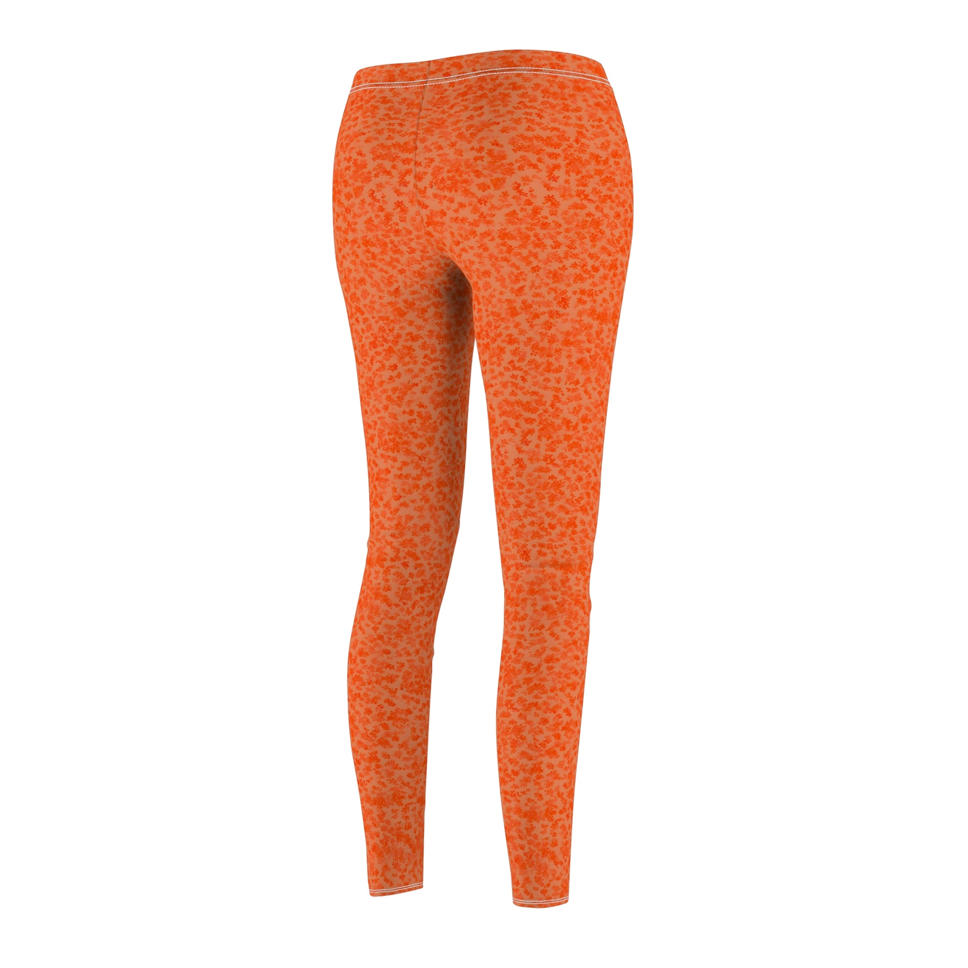 A pair of orange skinny fit leggings with a pattern, made from polyester and spandex fabric. Back side view.