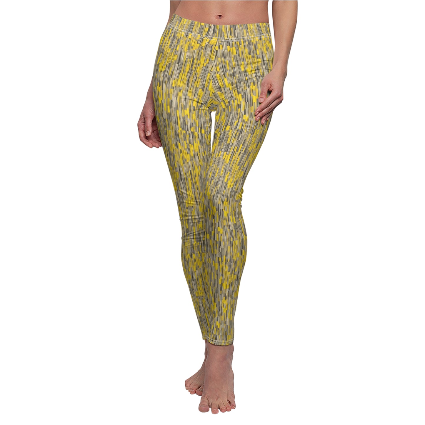 A pair of leggings with a vibrant yellow and gray geometric pattern, displayed on a model.