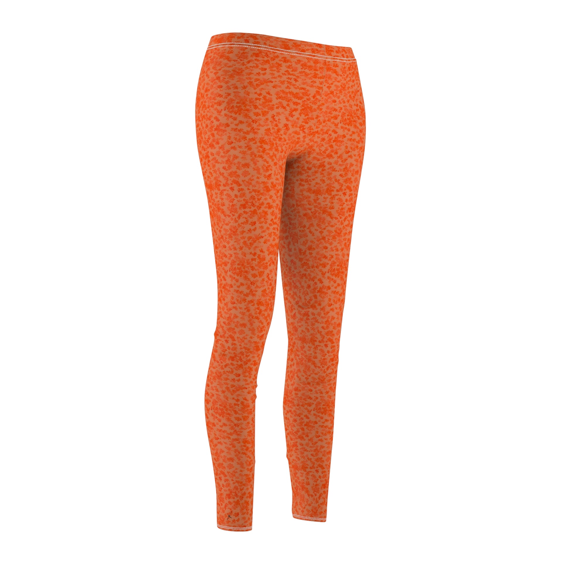 A pair of orange skinny fit leggings with a pattern, made from polyester and spandex fabric. Front side view.