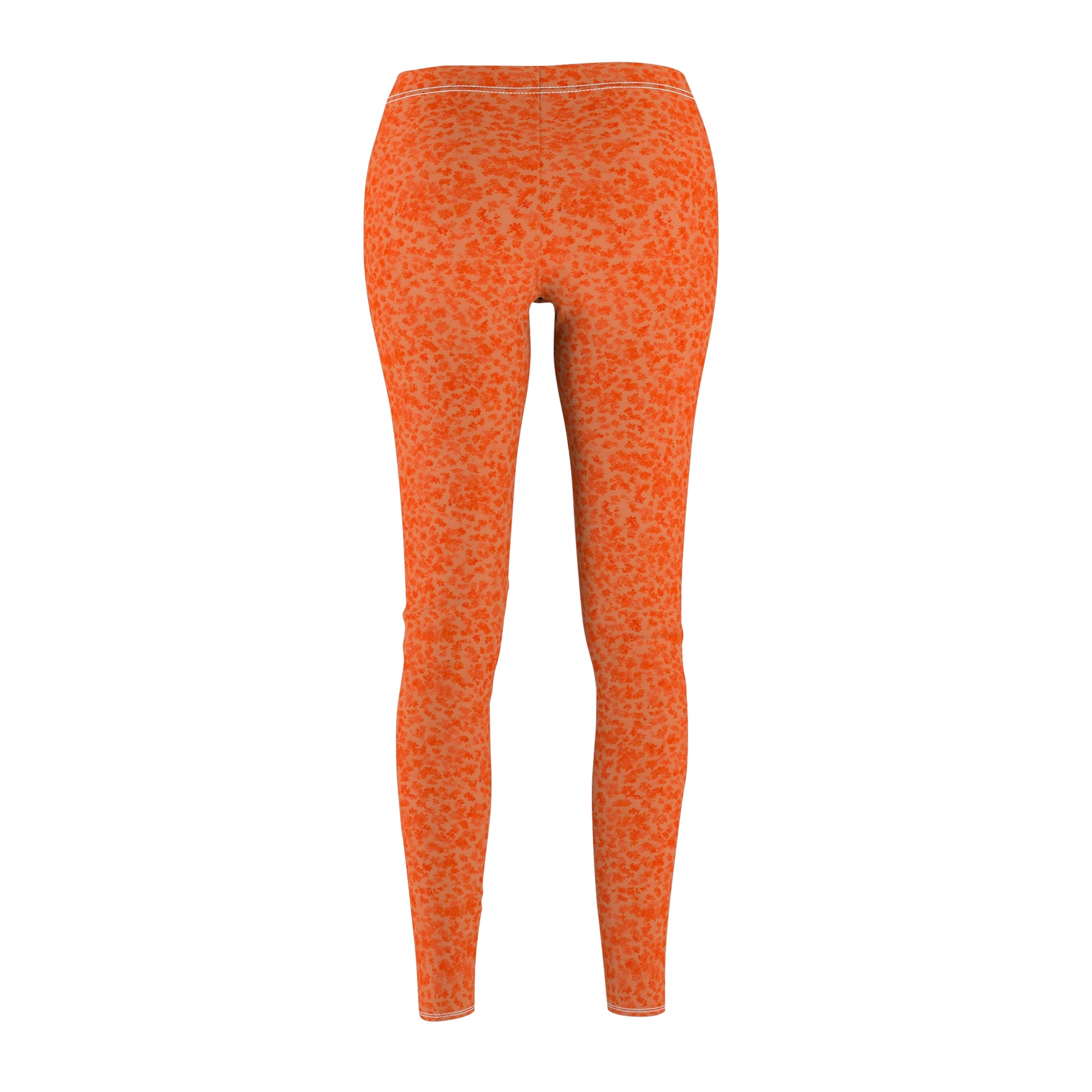 A pair of orange skinny fit leggings with a pattern, made from polyester and spandex fabric. Back view.