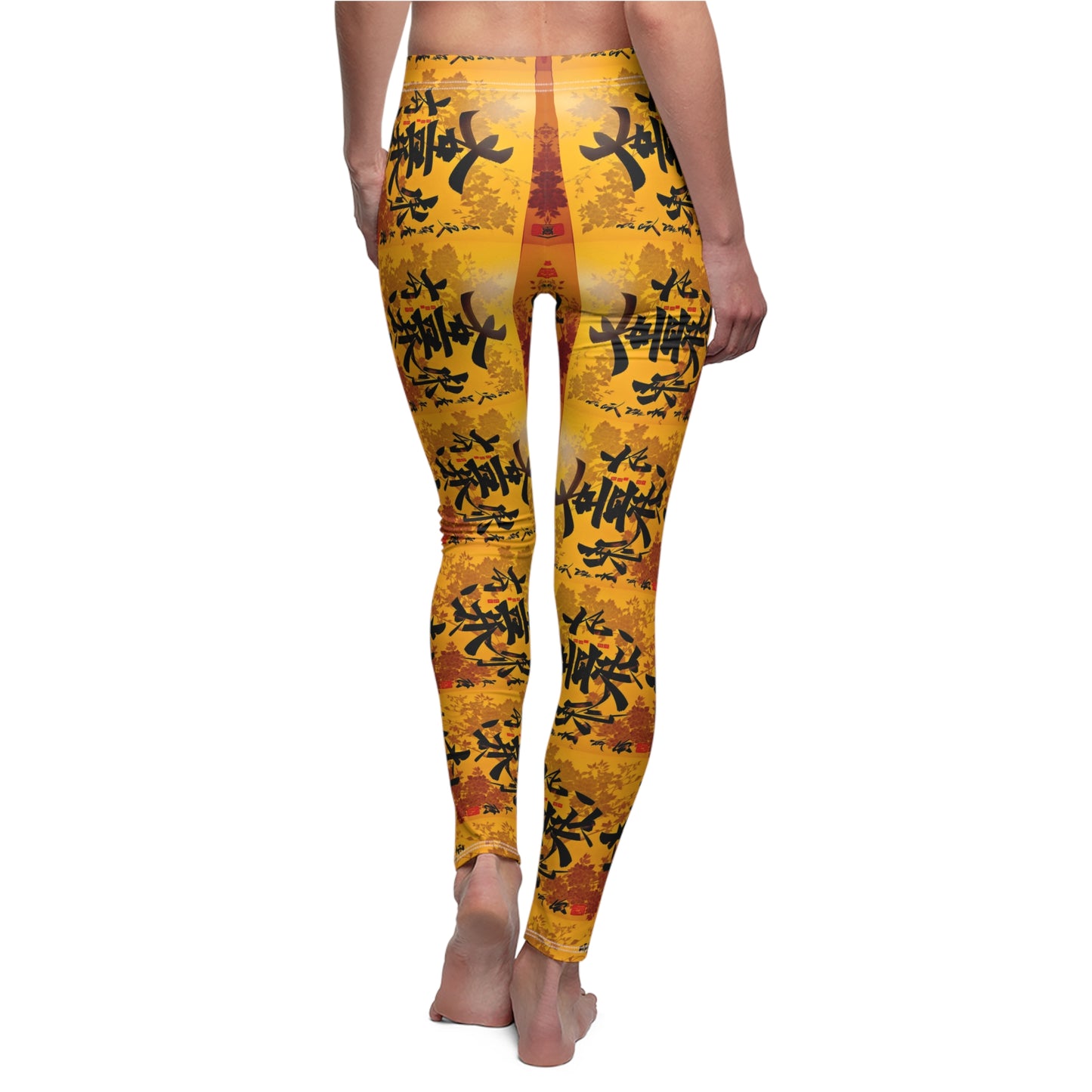 A pair of skinny fit leggings featuring a colorful all-over print, with a gold, black and orange Oriental design, back view, worn by model.