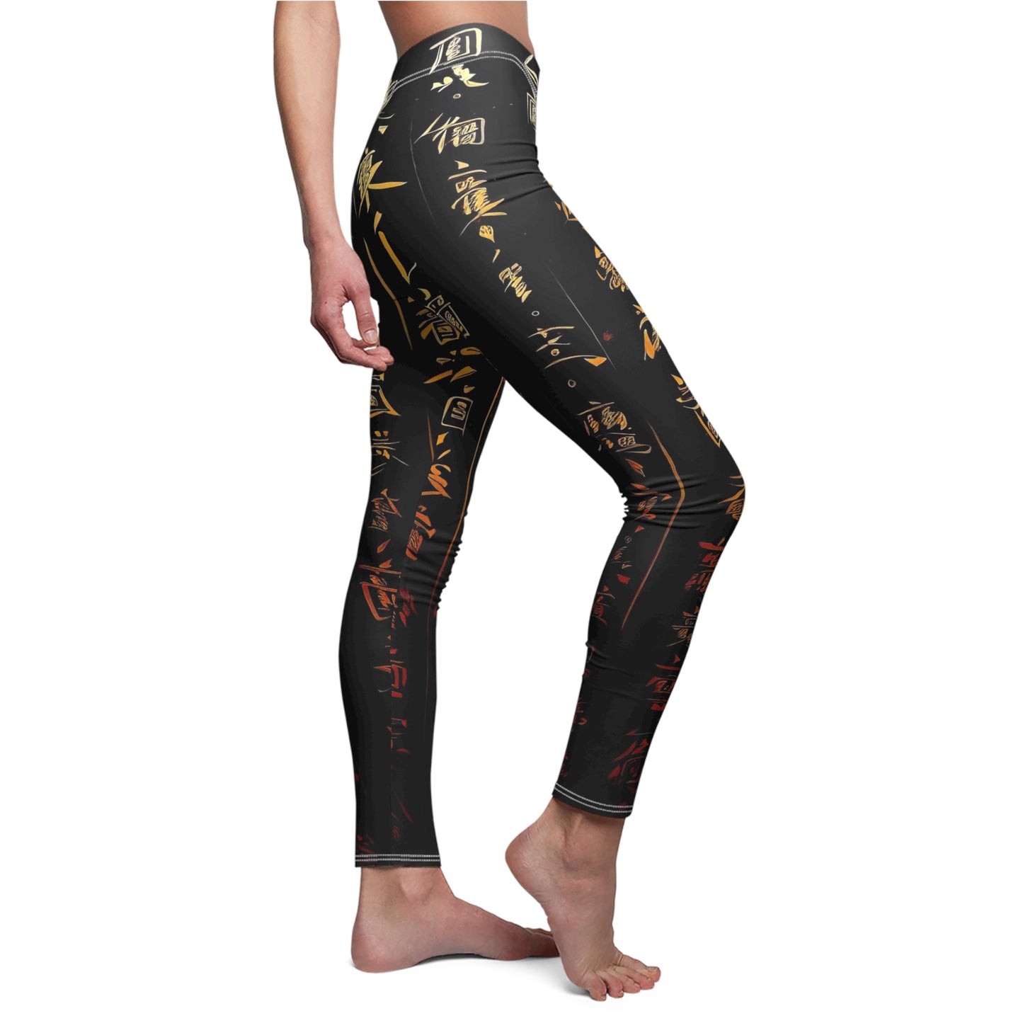 A pair of skinny fit leggings featuring gold and red Chinese lettering on a black background, worn by model, side view.