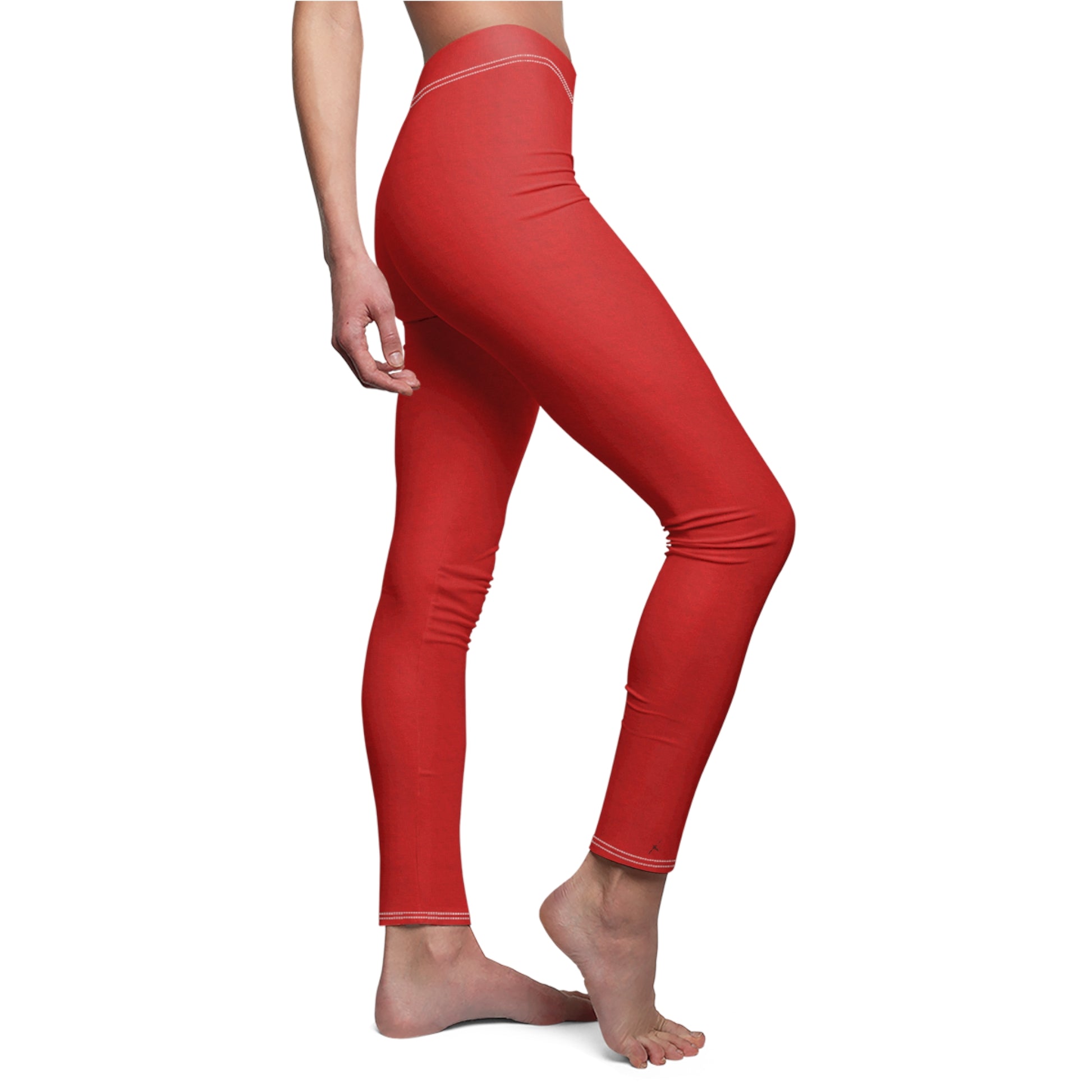 A pair of solid red skinny fit leggings with white thread color at the elastic waistband.