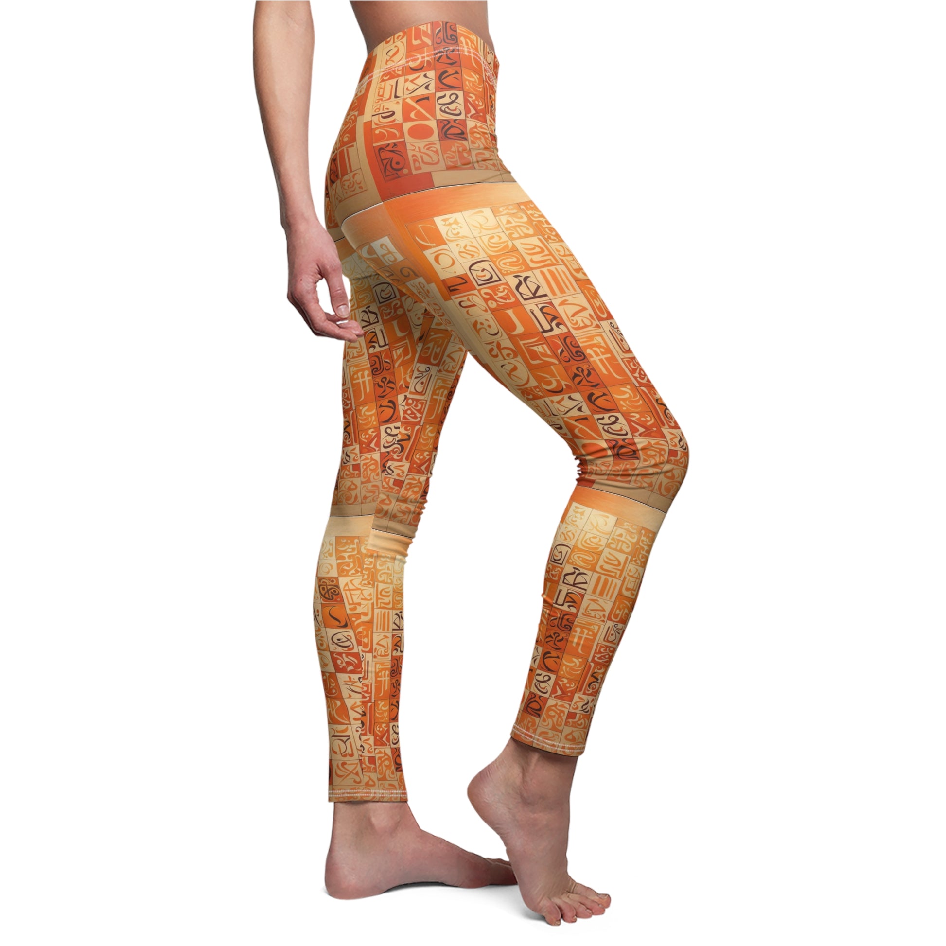 A pair of skinny fit leggings with geometric patterns in orange, creams, and browns with black and cream calligraphy on a female model, side view.