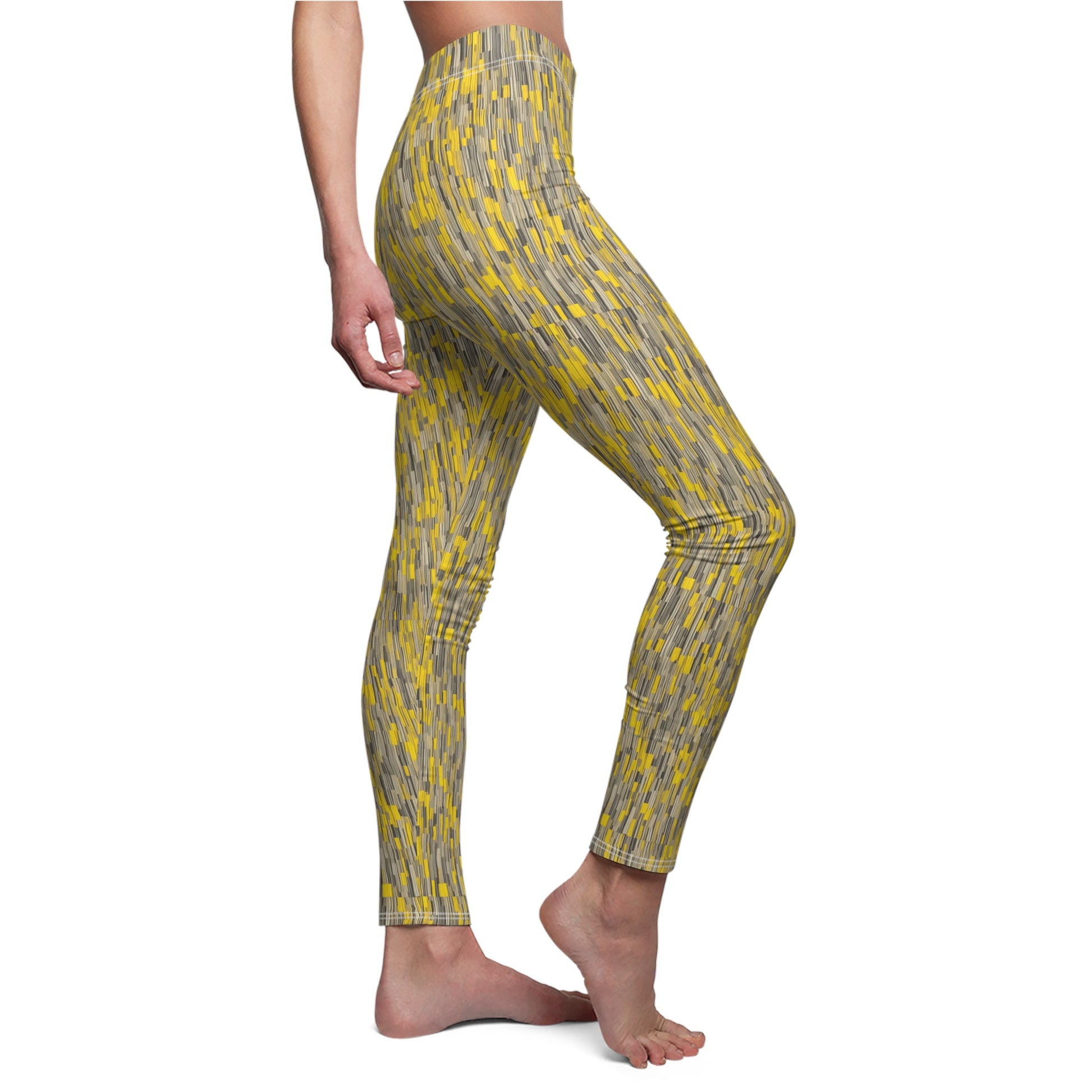 A pair of leggings with a vibrant yellow and gray geometric pattern, displayed on a model. Side view.