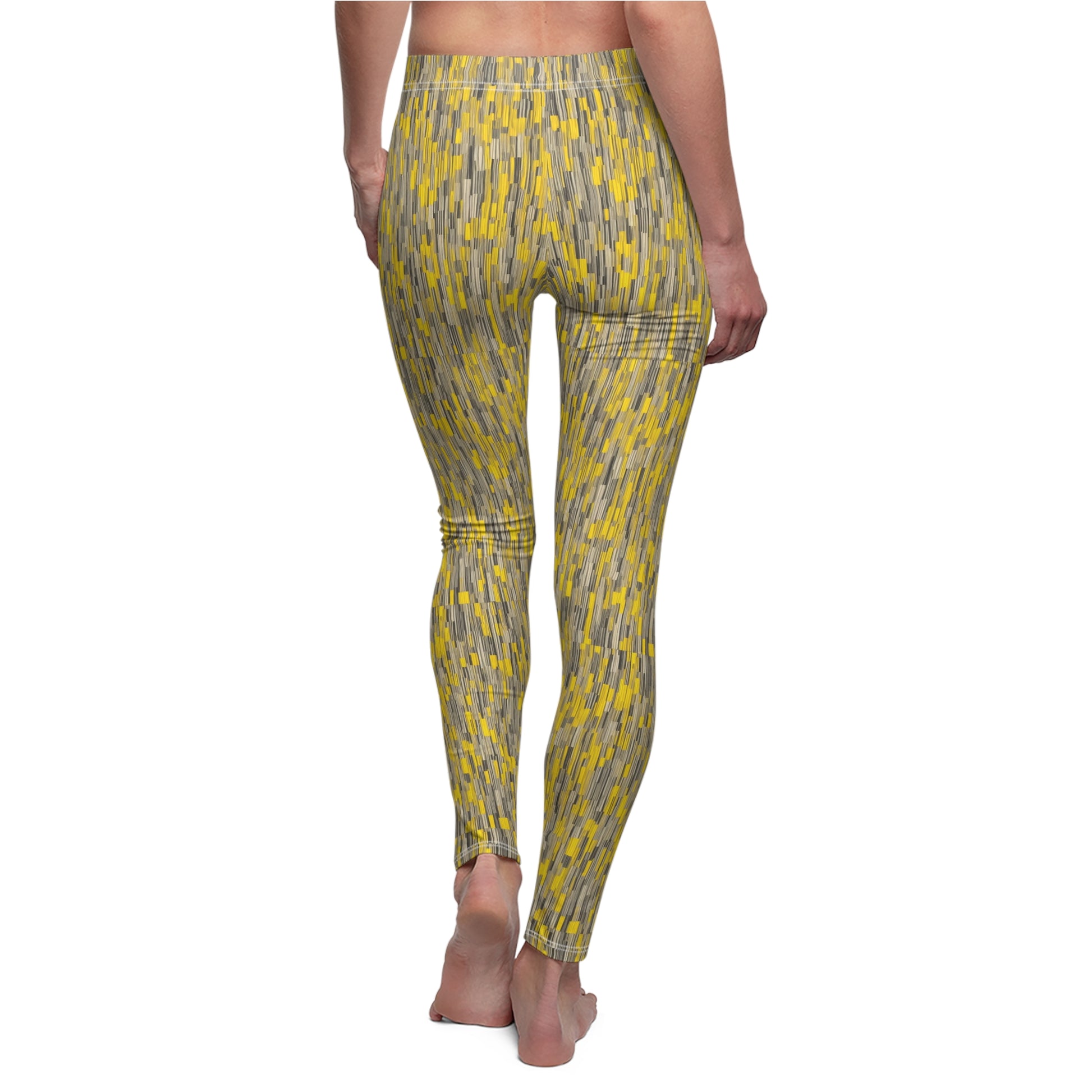 A pair of leggings with a vibrant yellow and gray geometric pattern, displayed on a model. Back view.